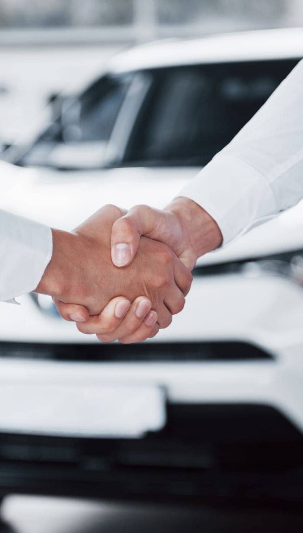 close-up-sales-manager-black-suit-selling-car-customer close-up-sales-manager-black-suit-selling-car-customer